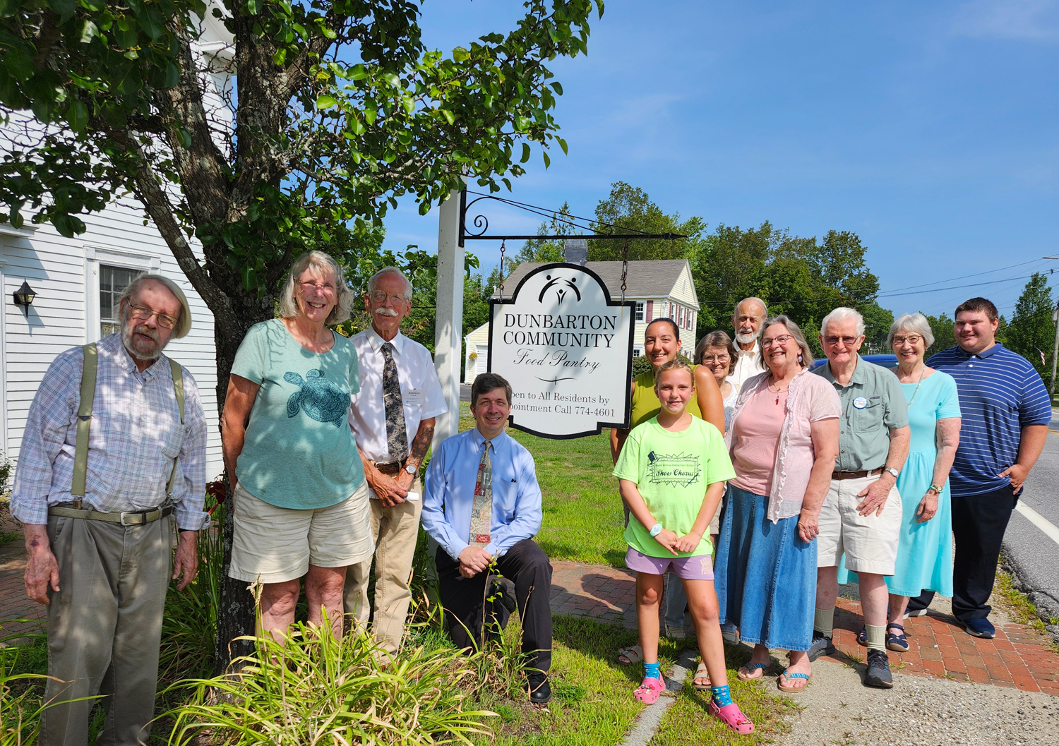 Church members in front of the Food Pantry sign